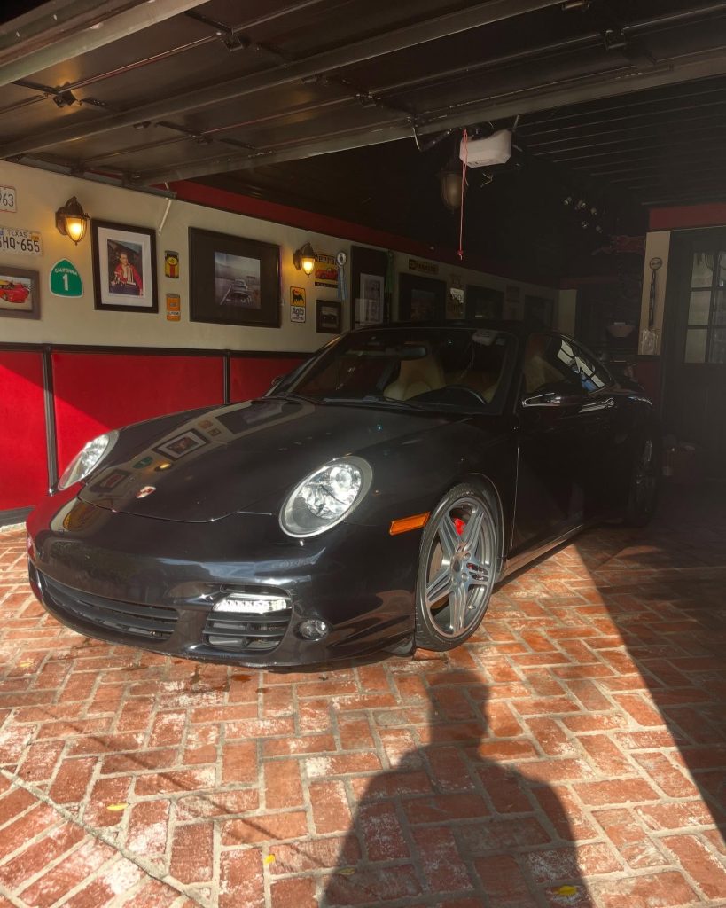 Black Porsche 911 kept showroom-clean in a San Fernando Valley home garage after detailing at Logan's